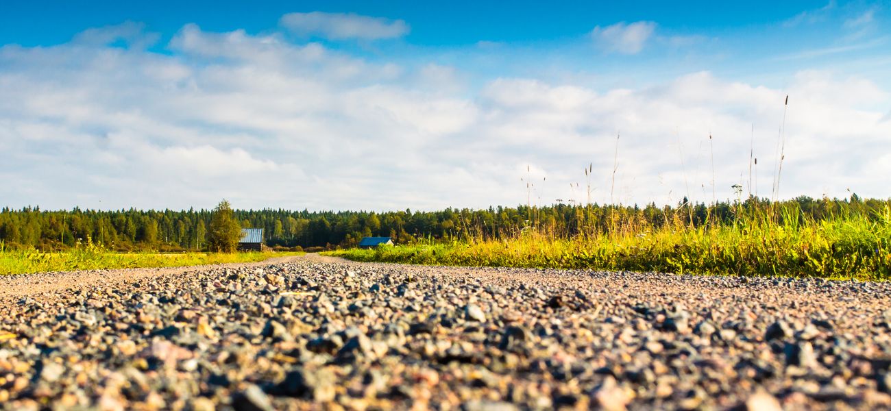 Close up image shot low to the ground of a gravel road representing public works in the RM of Reynolds.